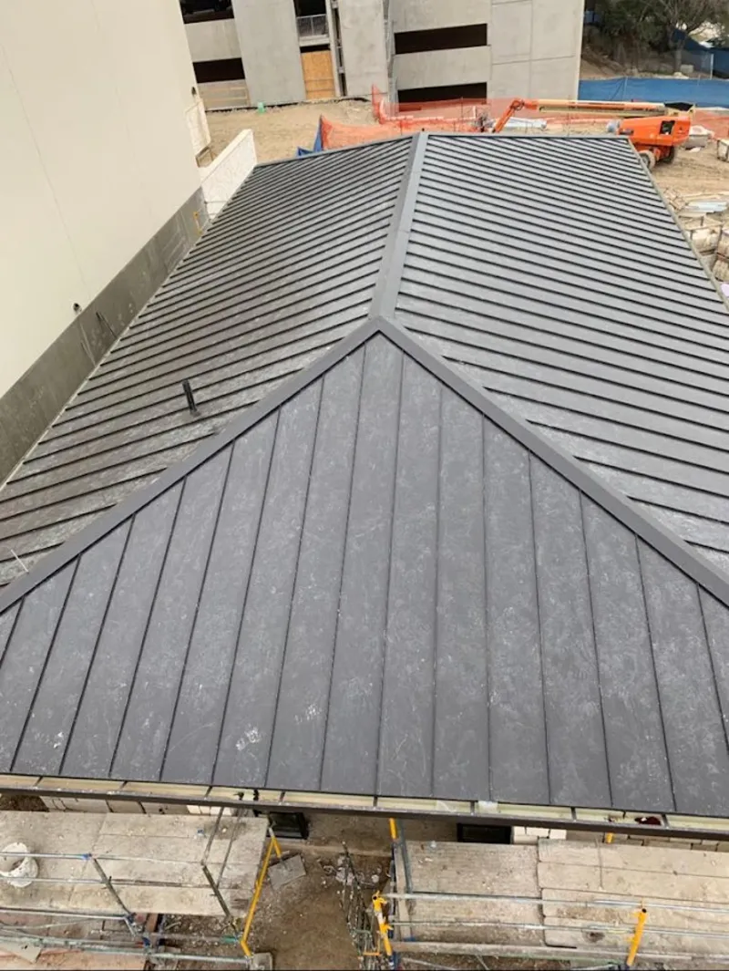 Commercial metal roof construction with crane equipment in Paradise